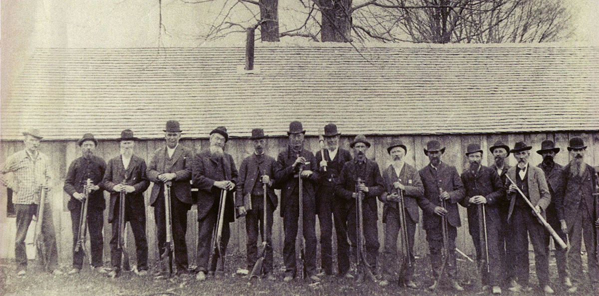 Competitors at the 40-rod match in Andover, Ohio, 1885. Left to right: “Doc” Kellog (Montana), Ben Garfield (Jamestown, N.Y.), Joe Bacon (Kiantone, N.Y.), Babcock (Jamestown, N.Y.), gunsmith H.V. Perry (Jamestown, N.Y.), C.L. Wilcox (Middlefield, OH), unknown, unknown, Judson Gould (Andover, OH), Cora Root, Holcomb (Andover, OH), gunsmith R.C. Rice (Warren, OH), unknown, Perry Hall gunsmith (Ashtabula, OH), unknown, unknown.